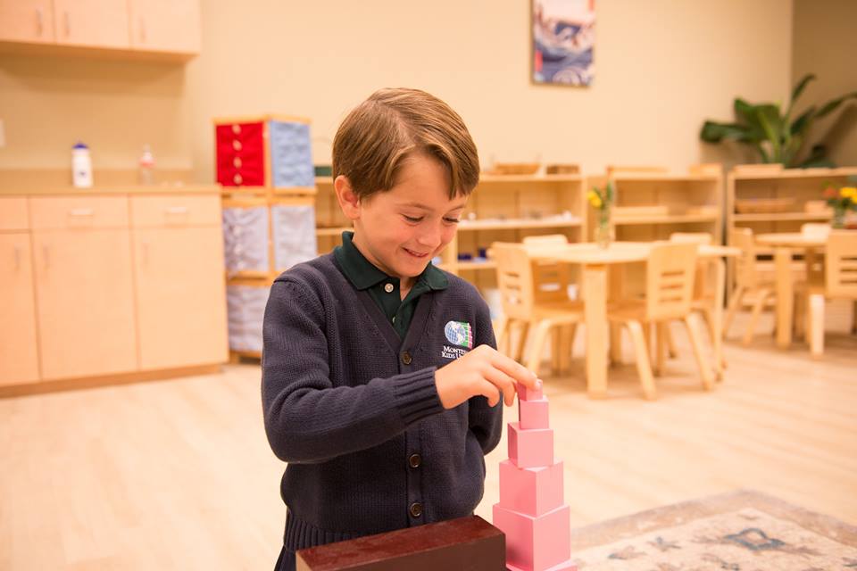 Montessori School pink blocks, montessori learning, early childhood education, child playing with pink blocks, montessori,