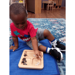 Child Playing with Montessori Materials