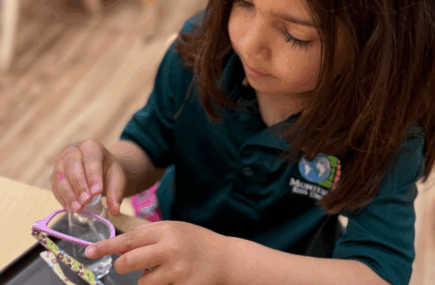 Child cleaning glasses independently