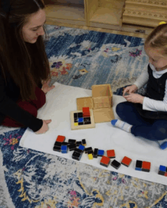 Montessori teacher observing a child working
