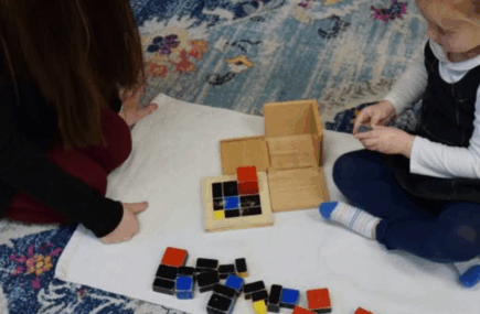 Montessori teacher observing a child working